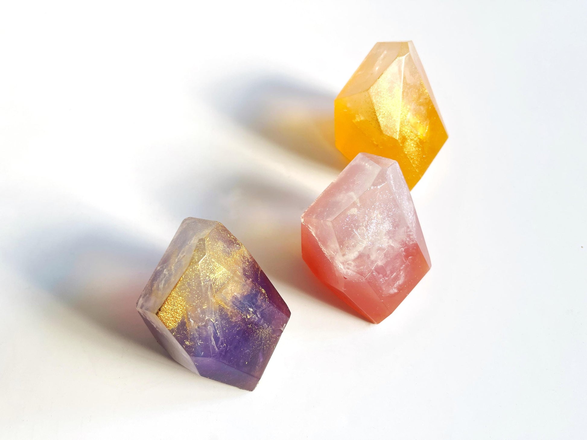 3 colorful crystal-like gem shaped soaps  on a white background