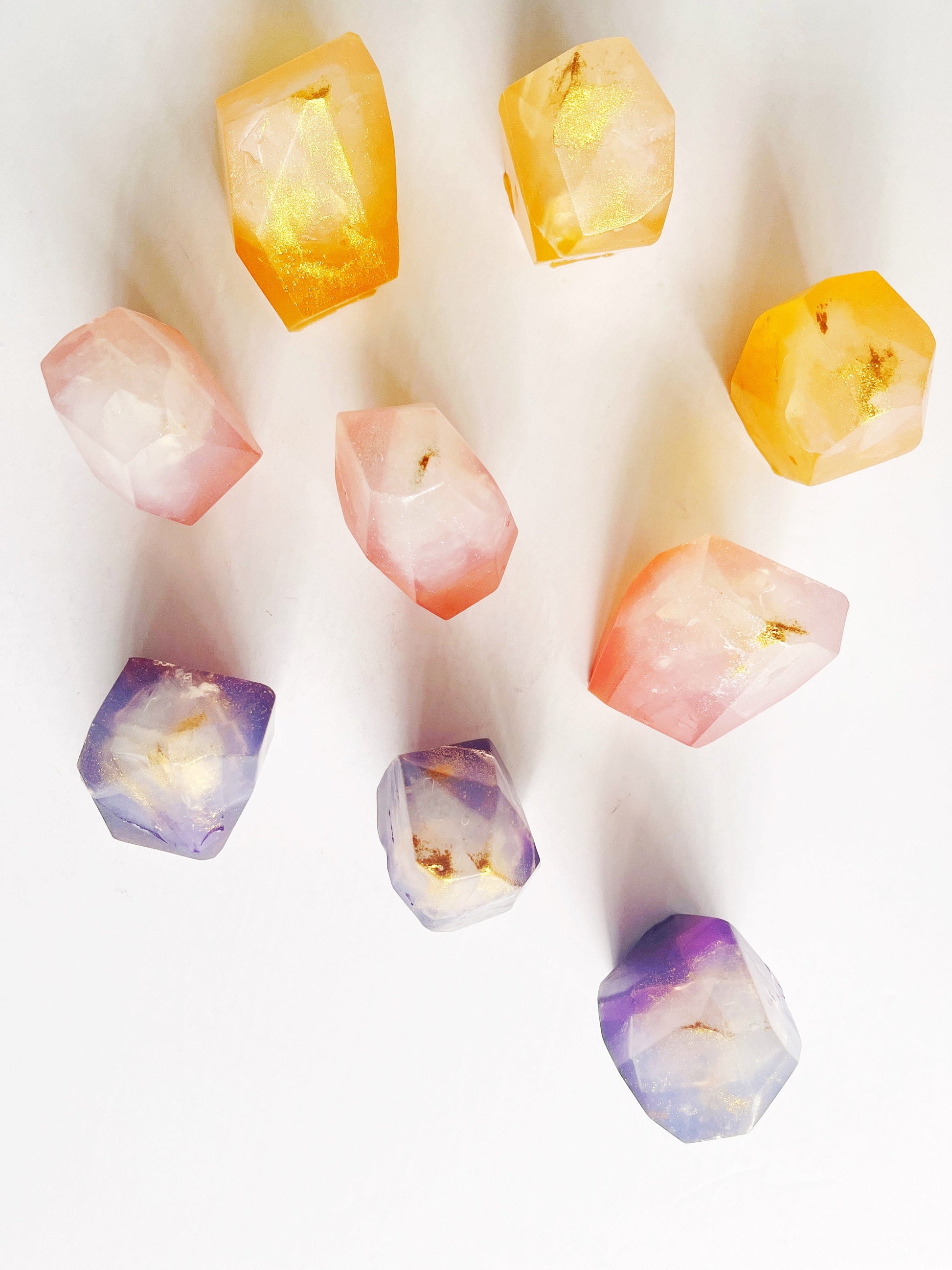 Colorful gem shaped soaps on a white background