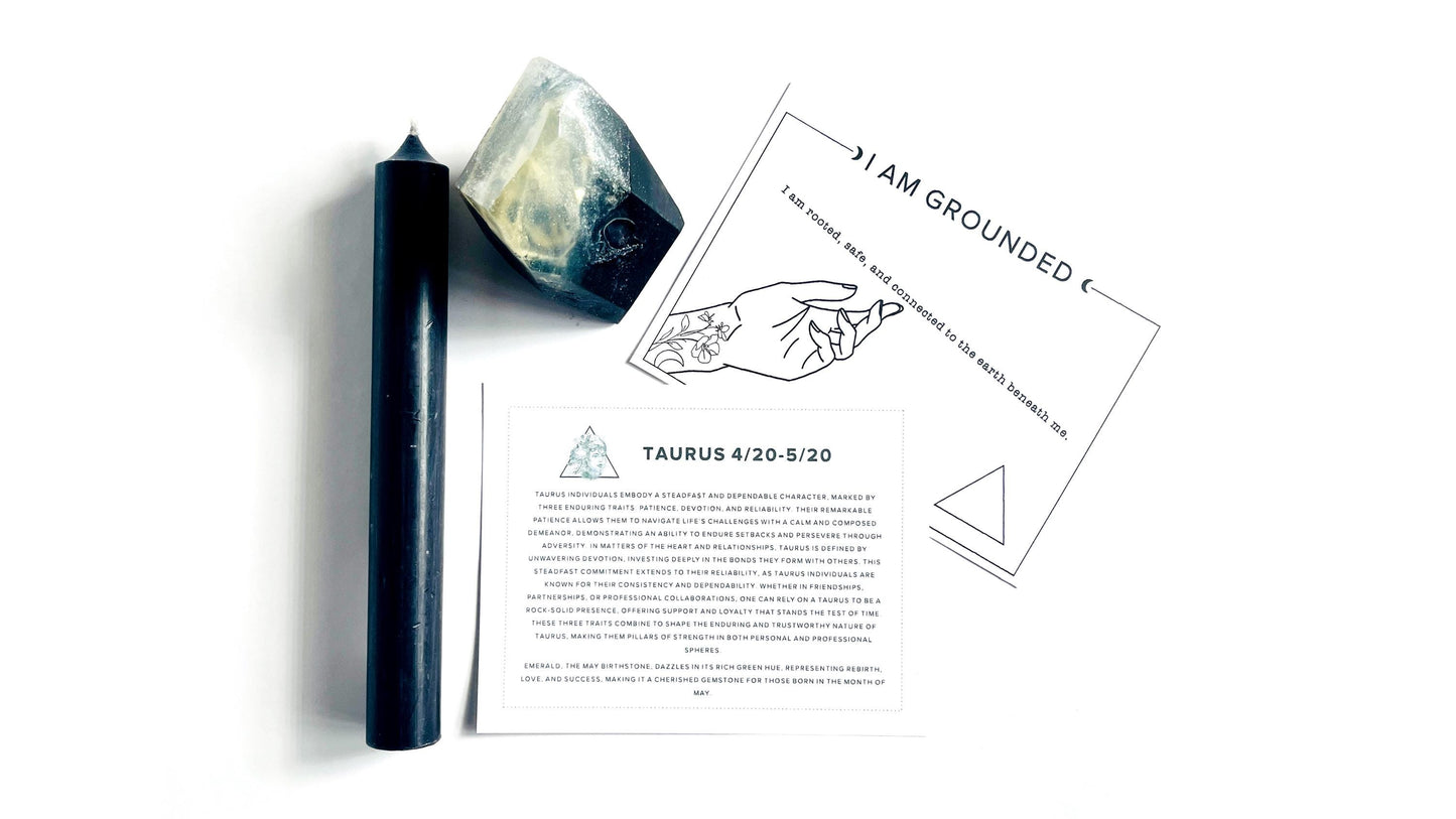 Black taper candle, smoky black crystal gem shaped soap, and printed material on a white background