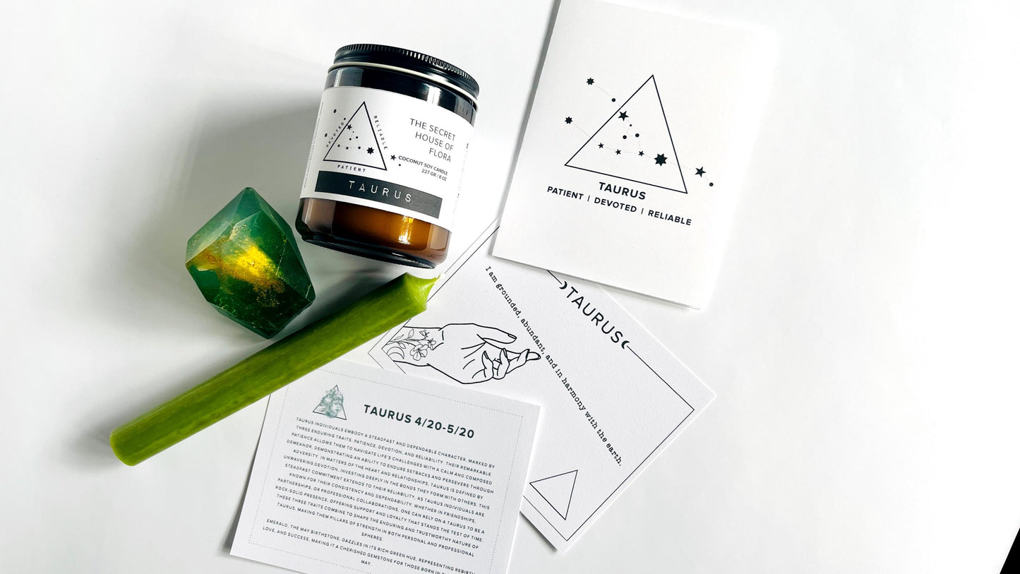 8oz Amber jar zodiac candle, taper candle, gem shaped soap, zodiac affirmation cards, and zodiac birthday card on a white surface