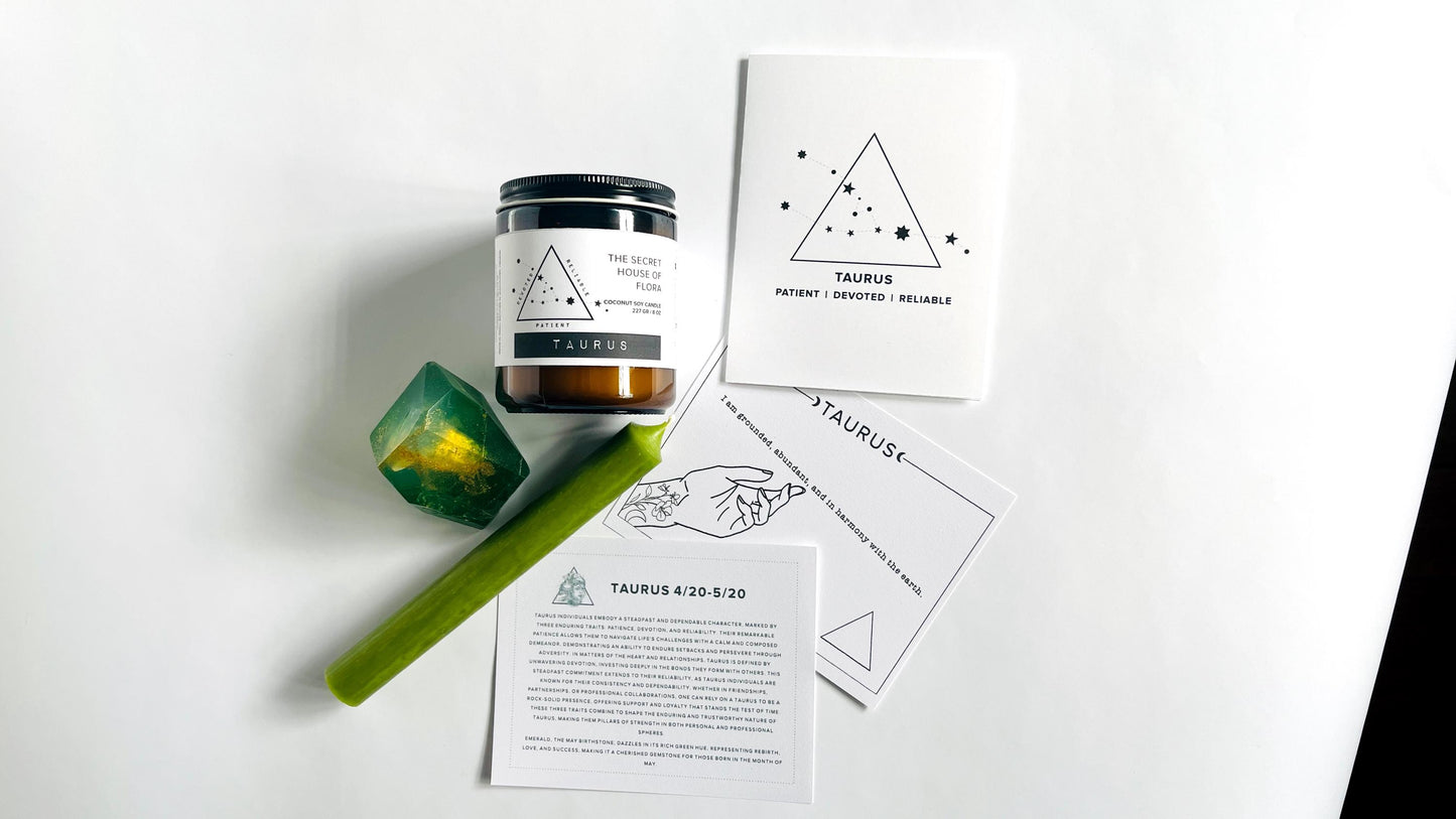 Zodiac candle with taper candle, gem shaped soap with affirmation cards, and zodiac birthday card on a white surface