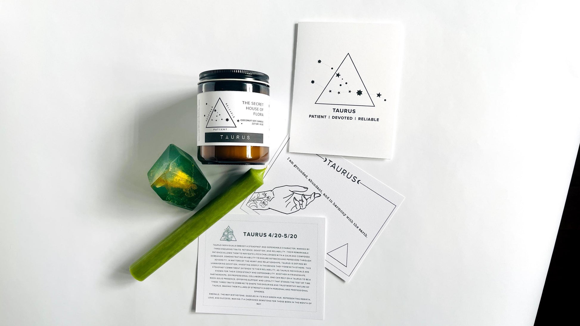 Zodiac candle with taper candle, gem shaped soap with affirmation cards, and zodiac birthday card on a white surface